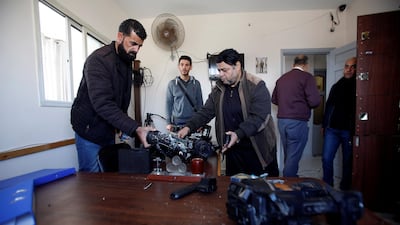 Employees inspect damaged equipment at Palestinian government-run radio and television stations in Gaza after they were ransacked by armed men. Reuters