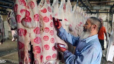 An Egyptian butcher prepares slaughtered sacrificial sheep in Cairo. EPA