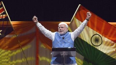 Prime Minster of India Narendra Modi acknowledges thousands of supporters at the Allphones Arena Olympic park in Sydney on November 17, 2014. Thousands of Indian community members gathered at the arena to listen to Modi who is in Sydney after attending the G20 Summit in Brisbane over the weekend. AFP PHOTO / Saeed KHAN