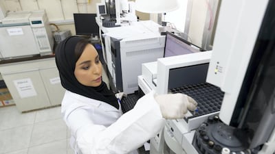 Leena Al Ghais tests samples at the Sharjah Police Forensic Laboratory. Antonie Robertson / The National