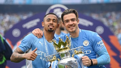 Gabriel Jesus and Jack Grealish celebrate with the Premier League trophy. Getty