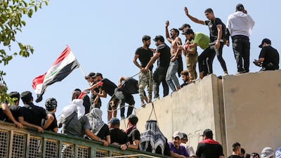 Angered by a nomination for Iraq's role of prime minister, supporters of Shiite cleric Moqtada Al Sadr haul down concrete barriers along the Al Jumhuriya Bridge that leads to Baghdad's high-security government and administration Green Zone. AFP