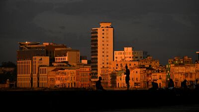 Cubans gather at the Malecon waterfront at sunset during blackout in Havana. AFP