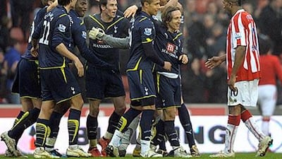 Tottenham players celebrate after yesterday's 2-1 win away at Stoke City.