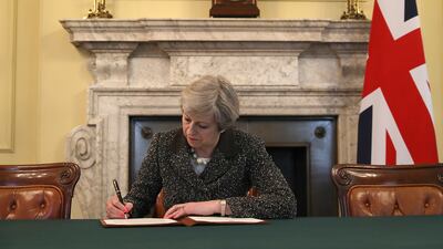 Ms May signs the official letter to European Council President Donald Tusk invoking Article 50 and the United Kingdom's intention to leave the EU, in March 2017