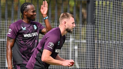 England’s Gus Atkinson bowls as Jofra Archer looks on. AFP