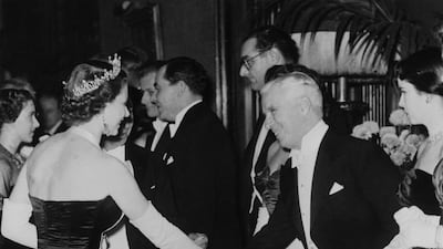 Queen Elizabeth II meets actor Charlie Chaplin at the Empire Theatre in London. Getty