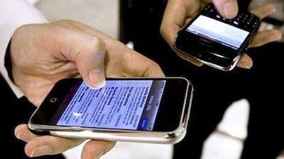 Increasing use of smartphones and other devices in the office can be a problem for IT managers as they struggle to adapt. Jeff Topping / The National