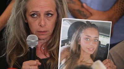 Keren Shelf holds up a picture of her daughter, Israeli-French citizen Mia Shem, held hostage by Hamas. EPA