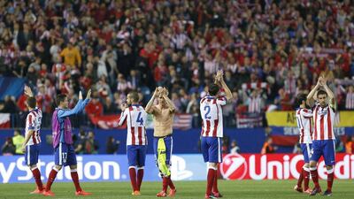Atletico Madrid players acknowledge their supporters at the end of the 0-0 Champions League quarter-final first leg draw against Real Madrid on Tuesday night at the Vicente Calderon. Alberto Martin / EPA
