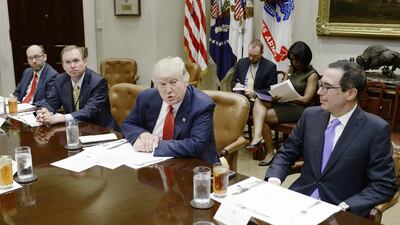 US president Donald Trump, centre, discusses the federal budget as US treasury secretary Steve Mnuchin, right, looks on. Olivier Douliery / EPA