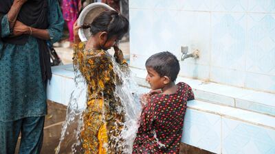 A quick wash at a temporary camp set up amid warnings over Biparjoy's impact in Badin, Pakistan. EPA