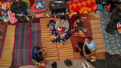 Displaced people take refuge at an evacuation centre in Surin, north-east Thailand, from fighting along the border with Cambodia. Getty Images