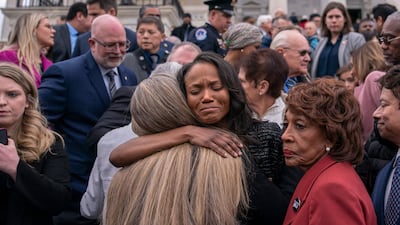 Serena Liebengood, centre, wife of late US Capitol Police Officer Howard Liebengood, is embraced by members of Congress. Getty / AFP