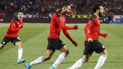 Mohamed Salah, Amr el-Solia, and Ahmed Fattoh celebrate the goal against Senegal in Cairo on Friday. AFP