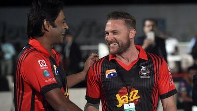 Former New Zealand captain Brendon McCullum, right, shakes hands with Lahore Qalandars director – and former UAE coach – Aaqib Javed after signing for the franchise for the second edition of the Pakistan Super League. Aamir Qureshi / AFP