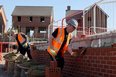 Bricklayers on a Barratt Homes development site. Shares in housebuilders surged on Wednesday as falling inflation brought interest rate expectations lower. PA