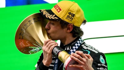 Mercedes' Kimi Antonelli celebrates with the trophy on the podium after winning the Chinese Grand Prix. AFP