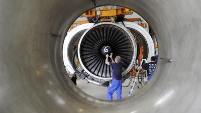 Workers are installing an aircraft engine in Hanover in a hall of the engine manufacturer MTU Maintenance. Nigel Treblin / dapd