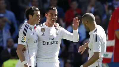 Cristiano Ronaldo, centre, celebrates his second goal with Gareth Bale, left, and Karim Benzema. Juan Carlos Hidalgo / EPA