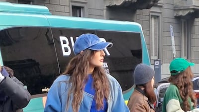 A teddy bear being carried as a handbag