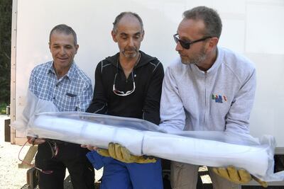 Researchers carrying a part of an ice core in Chamonix, eastern France, following its extraction as part of the Protecting Ice Memory project. AFP