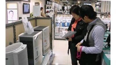 People shop for air purifiers in Beijing, where air quality has become a hot topic.