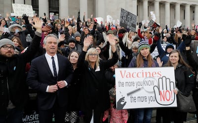 Robert F Kennedy Jr, left, attends a 2019 protest opposing a bill to tighten measles, mumps and rubella vaccine requirements for school-aged children. AP