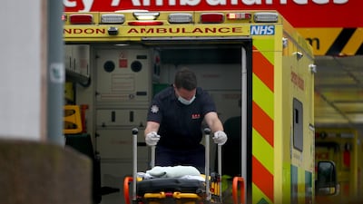 A paramedic moves a stretcher inside an ambulance at St Thomas' Hospital. Getty Images