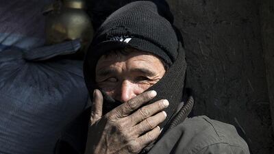 A partially-sighted Afghan man sits in a coal shop in Kabul.