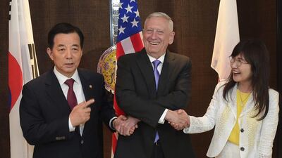 Jim Mattis links hands with South Korea's defence minister Han Minkoo, left, and Japan's defence minister Tomomi Inada ahead of a trilateral meeting at the 2017 International Institute for Strategic Studies (IISS) Shangri-la Dialogue on Saturday, June 3, 2017 in Singapore. AP Photo/Joseph Nair