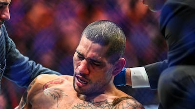 Alex Pereira is treated by medics after being knocked out by Israel Adesanya at UFC 287.