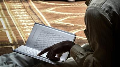A Muslim Cuban man reading the Quran at the Abdallah mosque.