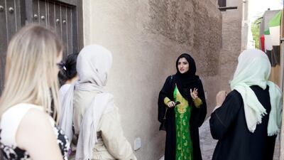 Heba bin Redha, founder of tour company Kashta With Heba, takes a group on a walk around Old Dubai. Anna Nielsen for The National