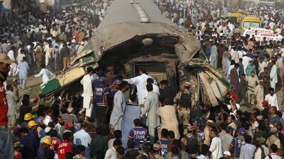 Pakistani volunteer rescuers work at the site of a train accident in Karachi, Pakistan. A passenger train crashed into the back end of another in Pakistan’s southern port city of Karachi on Thursday, killing many people and injuring others, officials said. Shakil Adil / AP