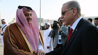 Qatar's Minister of State for Defence, Khalid bin Mohammad Al Attiyah, welcomes Mr Erdogan at the airport in Doha. AFP