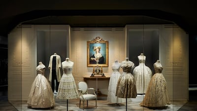 A room of pale gowns in the Christian Dior: Designer Of Dreams exhibition. Photo by Adrien Dirand