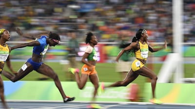 Jamaica’s Elaine Thompson (R) crosses the finish line of the women’s 100m final during the athletics event at the Rio 2016 Olympic Games at the Olympic Stadium in Rio de Janeiro on August 13, 2016. Fabrice Coffrini / AFP