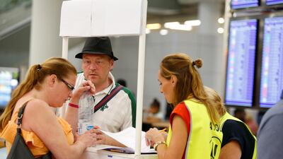 Passengers talk to Civil Aviation Authority employees at Mallorca Airport, in Palma de Mallorca, Spain. Reuters
