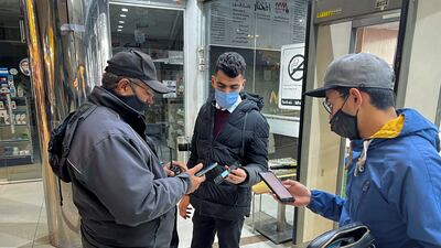 A security employee inspects people's vaccination status at the entrance of a shopping centre, amid a Covid-19 outbreak, in Amman, Jordan. Reuters