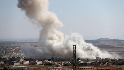 Smoke billows above buildings during a reported air strike by pro-regime forces on Khan Sheikhun in the Syria's Idlib province. AFP