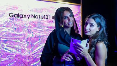 Dubai social media influencers and entrepreneurs Sara Madani and Melina Malliaroudakis check out the Note 10 at its launch in Dubai. All photos by Victor Besa / The National