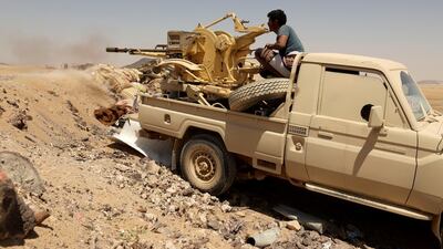 A Yemeni government fighter fires at a frontline position during battle with Houthi militants in Marib, Yemen. Reuters
