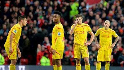 Liverpool's Philippe Coutinho, left, Raheem Sterling, Steven Gerrard and Martin Skrtel prepare to kick off after cenceding their second goal during their English Premier League football match against Manchester United on December 14, 2014. AFP PHOTO / OLI SCARFF