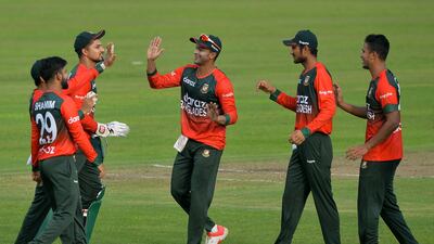 Bangladesh's cricketers celebrate after the dismissal of New Zealand's Henry Nicholls (not pictured) during the first Twenty20 international cricket match between Bangladesh and New Zealand at the Sher-e-Bangla National Cricket Stadium in Dhaka on September 1, 2021. (Photo by Munir Uz zaman / AFP)