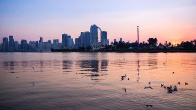 No. 6, SHARJAH, UAE. The sun sets over Khalid Lake, with Sharjah city visible. The city has become a major cultural draw for tourists, boasting libraries, architecture and popular visitor attractions. Reem Mohammed / The National