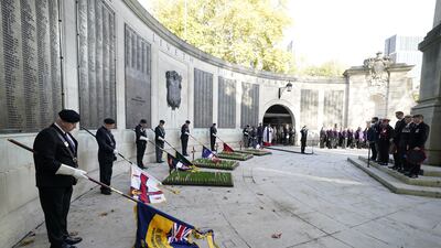Flag bearers, services veterans, and members of the public observe a two-minute silence at an Armistice Day service at the City of Portsmouth War Memorial in Guildhall Square. PA