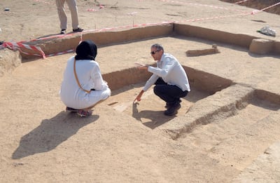 DCT - Abu Dhabi archaeologist Peter Sheehan showing an early Islamic irrigation channel in Al Ain to a student from Zayed University
