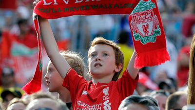 A Liverpool fan cheers during the match. AP Photo