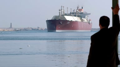 A Qatari LNG carrier passes through the Suez Canal near Ismailia. Egypt will now receive 24 LNG deliveries through the summer from Doha. AFP